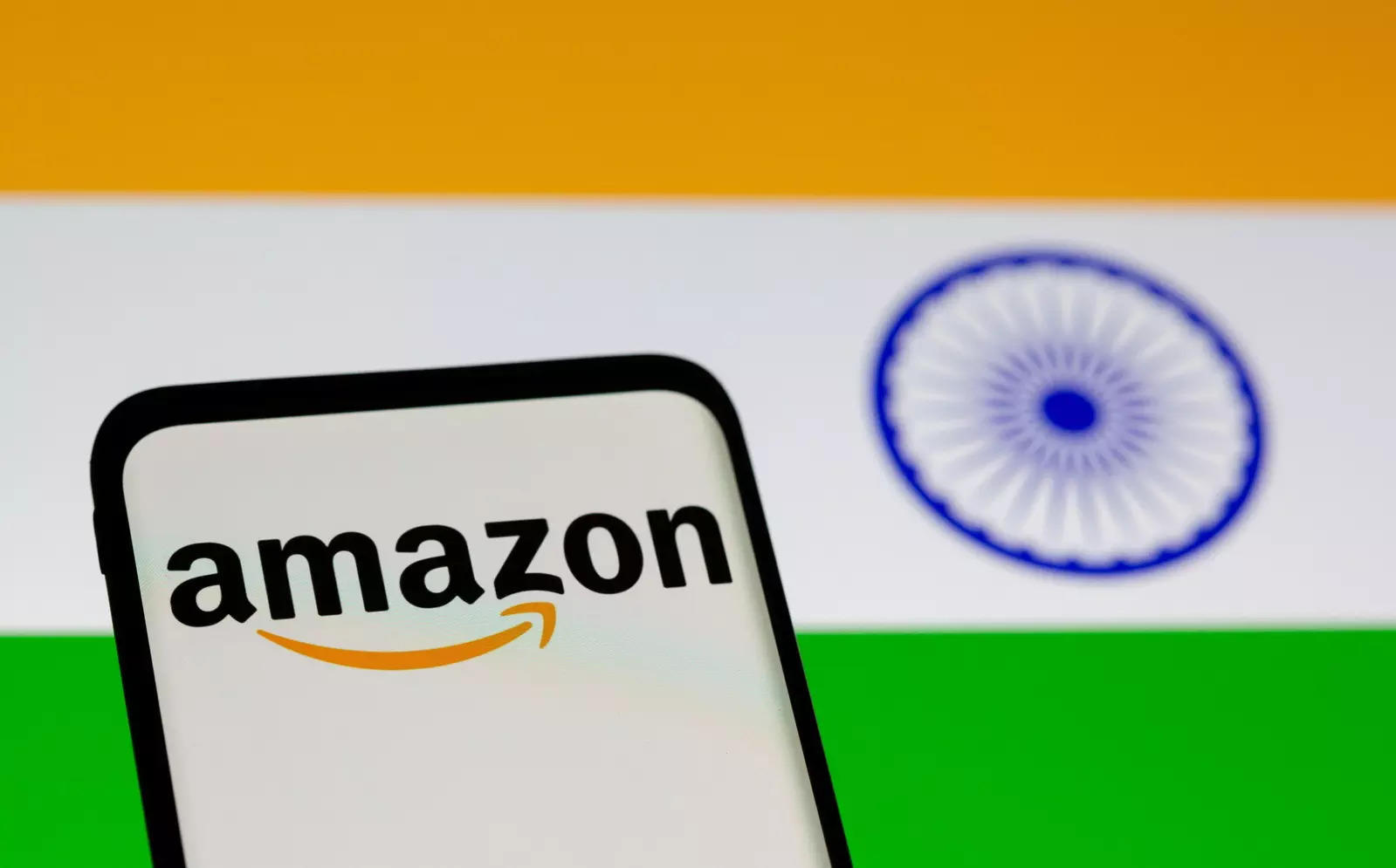 FILE PHOTO: Smartphone with Amazon logo is seen in front of displayed Indian flag in this illustration taken